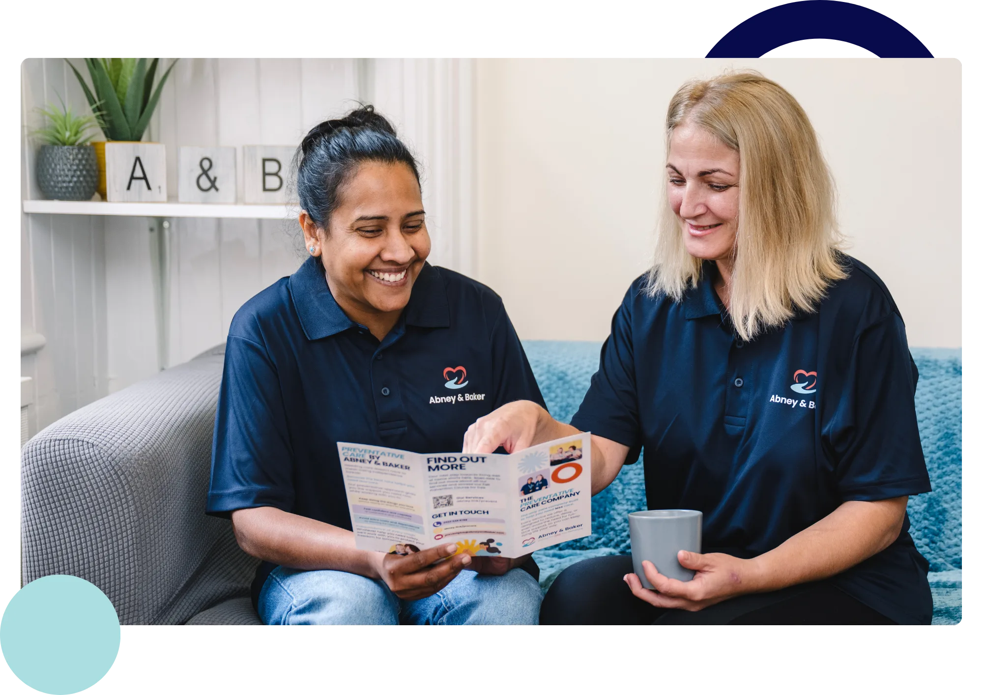 Two Abney & Baker carers looking through a preventative care brochure together