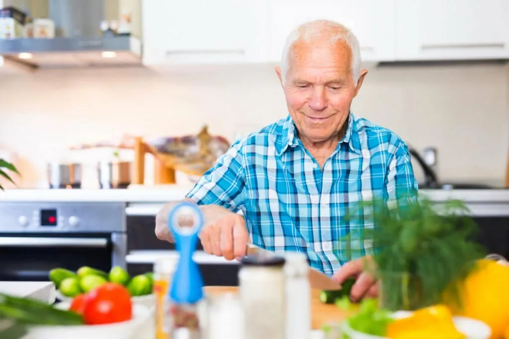 A specialist providing gentle in-home nail care for an older person